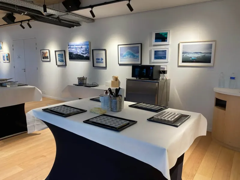 Salle d'atelier dressée avec moules à chocolat dans une galerie