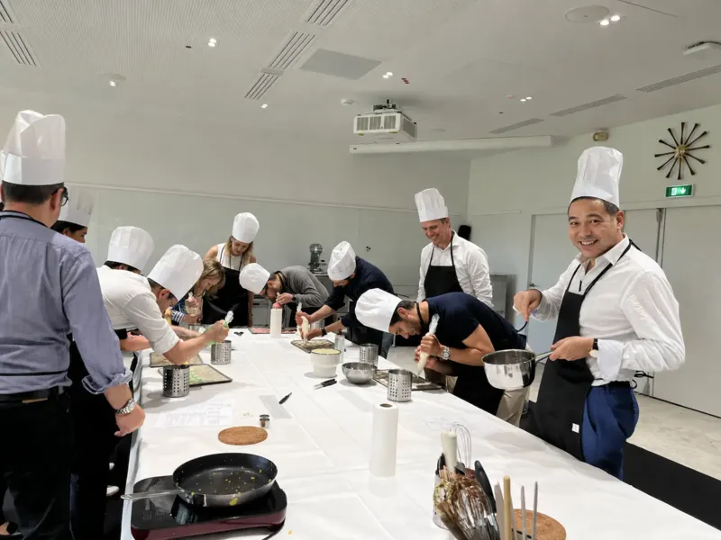 Chef montrant les macarons colorés au groupe attentif