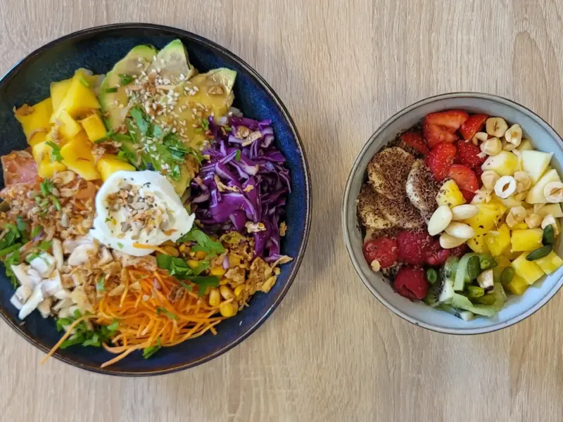 Poké bowl salé et bol de fruits frais vus de dessus