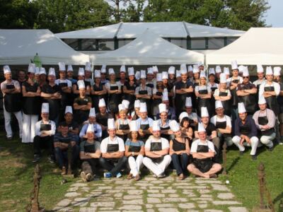 Photo de groupe des participants en toque et tablier à l'issue d'un Cooking Battle